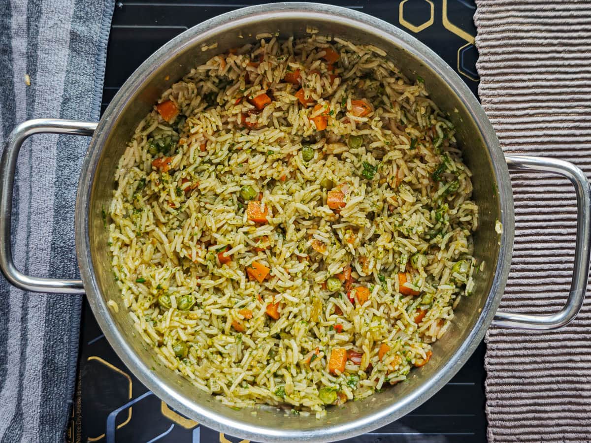 Easy Chimichurri Rice with Vegetables Rice with basil chimichurri in a metal pot.