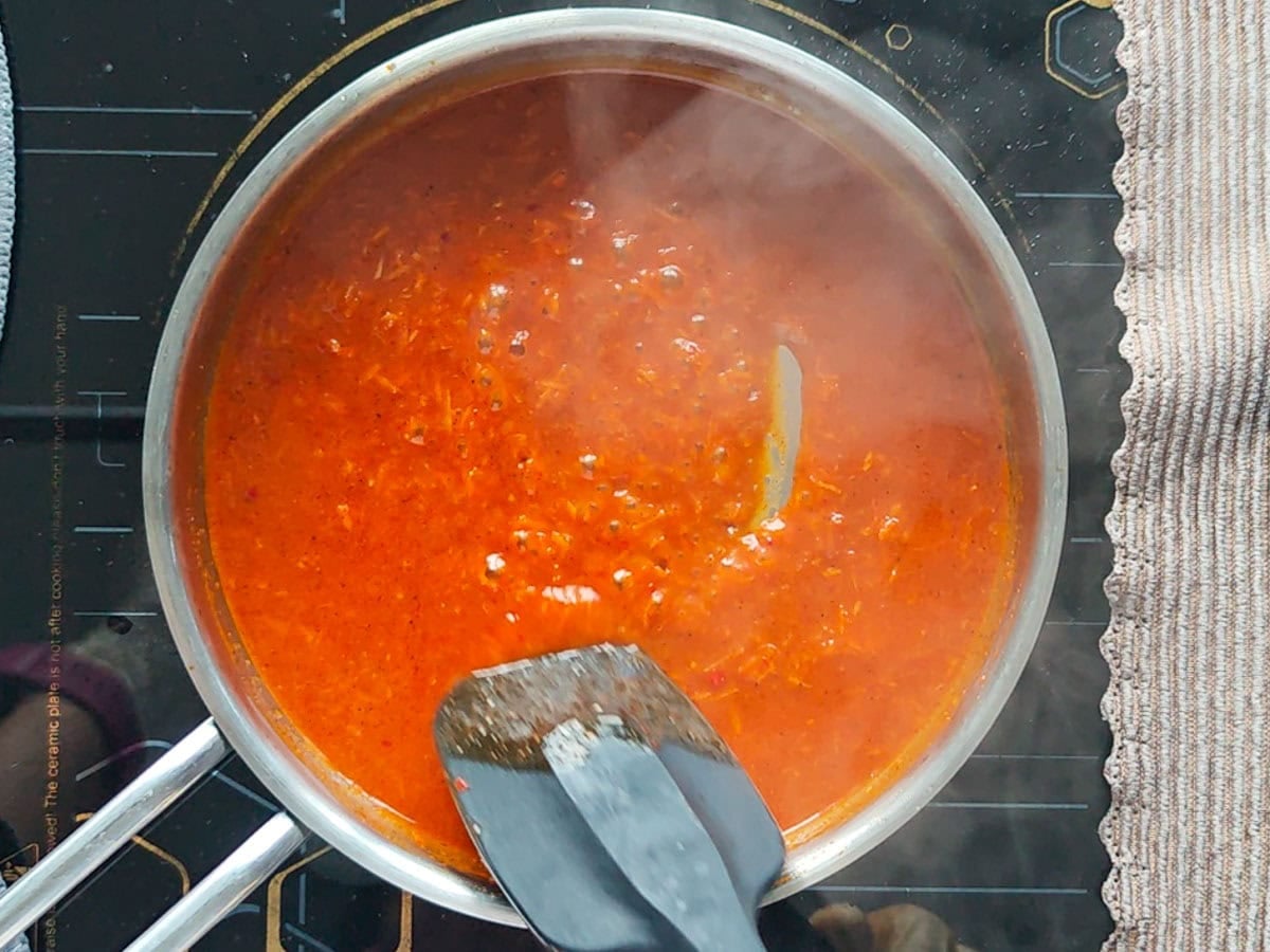 Easy Gochujang Chicken Thighs (Sticky & Oven-Baked) Gochujang marinade with water boiling in a saucepan.