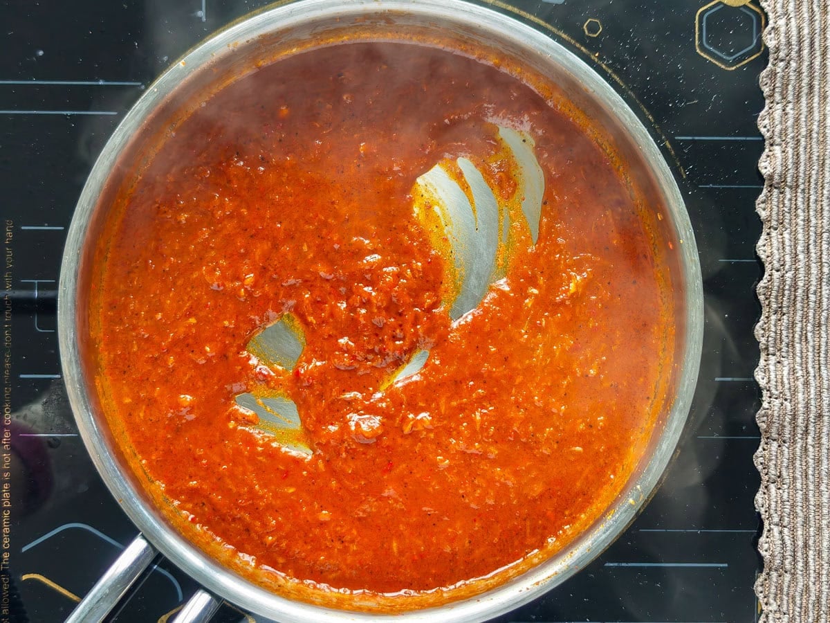Easy Gochujang Chicken Thighs (Sticky & Oven-Baked) Sticky gochujang sauce simmering in a saucepan.